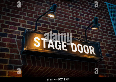 Close up of a Stage Door sign illuminated with spotlights at the Stage Door of Cambridge Theatre in Shelton Street, Covent Garden, London Stock Photo