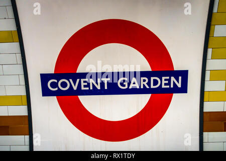 Iconic circular London  Tube sign on the underground platform at Covent Garden, London Stock Photo