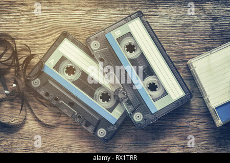 Two vintage audio cassette tapes on wooden background. Stock Photo