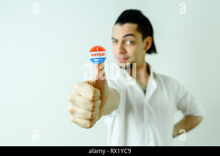 Man with sticker having voted on election day, isolated on white. Stock Photo