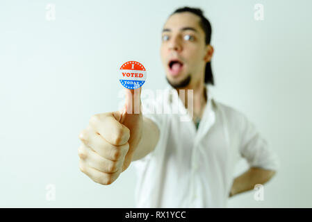 Man with sticker having voted on election day, isolated on white. Stock Photo