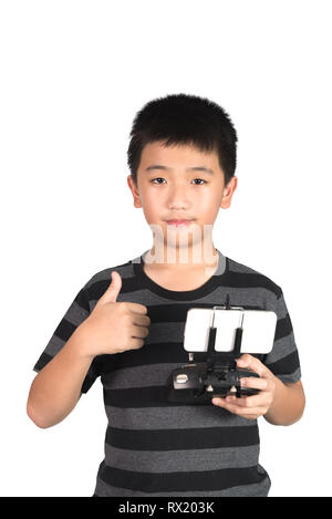 Asian boy holding radio remote control (controlling handset) for helicopter, drone or plane and giving thumbs up,  isolated on white background with c Stock Photo