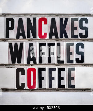 A Retro Vintage And Grungy Sign For A Breakfast Cafe Or Diner Advertising Pancakes, Waffles and Coffee Stock Photo