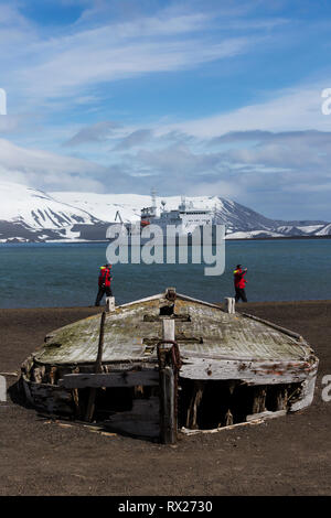 Relics of the past including these water boats used in the whaling industry lie strewn about the beach at Whaler's Bay on Deception Island.  South Shetland Islands Stock Photo