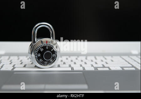 Computer security concept, padlock on laptop keyboard. Stock Photo