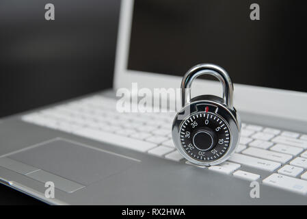 Computer security concept, padlock on laptop keyboard. Stock Photo