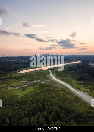 Aerial view of Burnaby Lake in the modern city during a vibrant summer sunset. Taken in Vancouver, BC, Canada. Stock Photo