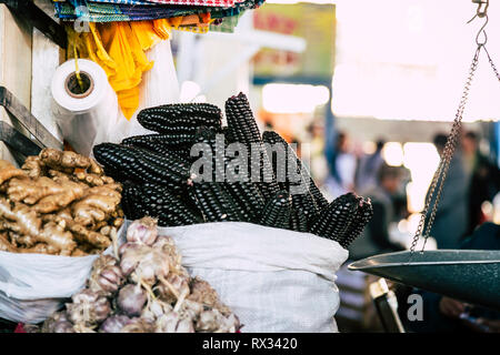 Black corn, ginger and garlic on display on a food stall in Mercado San Pedro market, Cusco, Peru. Stock Photo