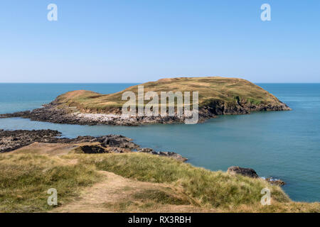 Burry Holms, Rhossili Bay (at the far end), Gower Peninsula, Swansea, South Wales, UK Stock Photo