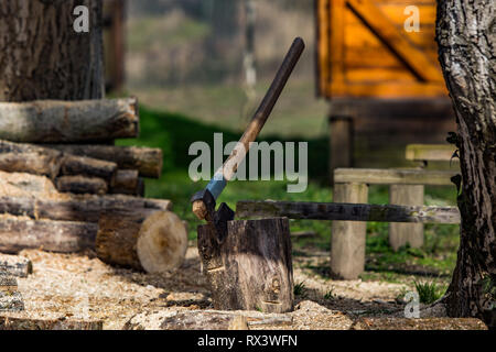Ax chopping wood, Firewood texture. Stacked firewood heap. Dry chopped firewood logs Stock Photo