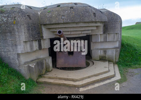 A 150mm gun in one of the four casements of the Longues-sur-Mer Battery, situated west of Arromanches-les-Bains in Normandy, France. Stock Photo