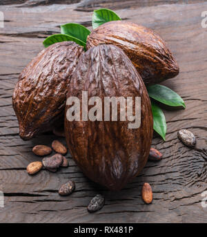 Cocoa pods and cocoa beans on the wooden table. Stock Photo