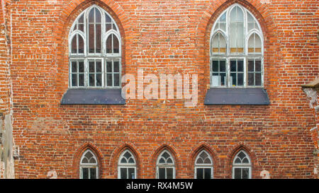 The red bricked wall old building. It is an old church from the medieval time with ruins seen on the wall Stock Photo