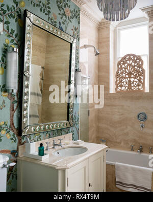 Mirror on wallpaper over washbasin Stock Photo