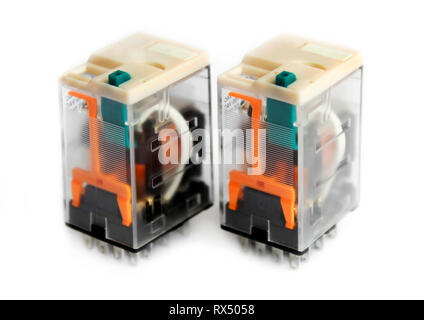 Two miniature relays in transparent plastic cases isolated on white background Stock Photo