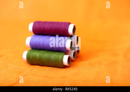 Picture of thread. Isolated on the yellow background. Stock Photo