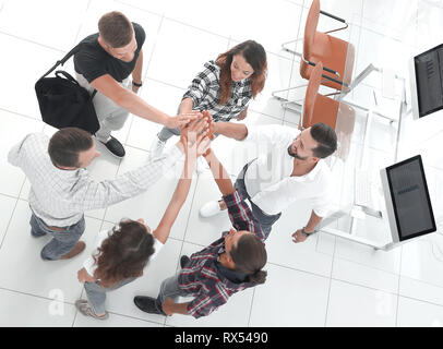 creative team giving each other a high five Stock Photo