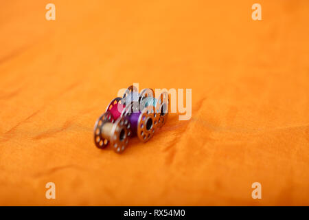 Picture of bobbins. Isolated on the yellow background. Stock Photo