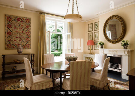 Country style dining room with striped chairs Stock Photo