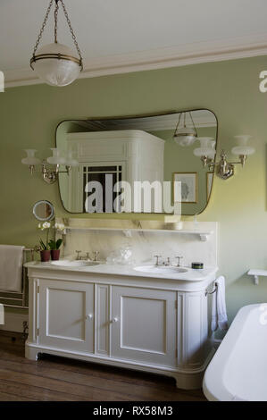 Washbasin in green and white bathroom Stock Photo