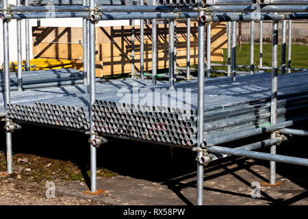 construction site scaffold storage area constructed using scaffolding poles Stock Photo
