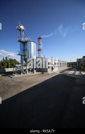 Wide-angle panoramic photo of the newest alternative fuel boiler room with pipes, towers and tanks, on a clear summer day, without people Stock Photo