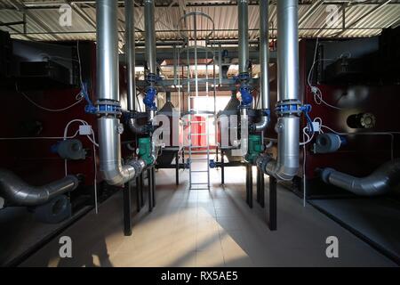 Wide-angle panoramic photo of the newest alternative fuel boiler room with pipes, towers and tanks, on a clear summer day, without people Stock Photo