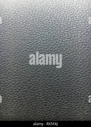 Close up of artificial shiny black leather pattern in a car Stock Photo