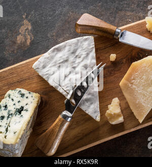 Cheese platter with blue cheeses on stone background. Top view. Stock Photo