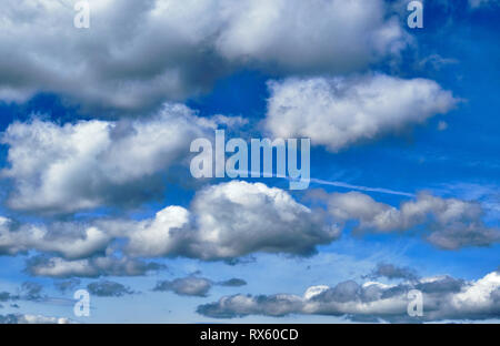 Pictured are clouds against a blue sky. Stock Photo