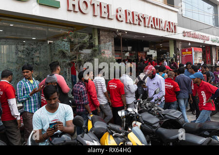 Hyderabad,India-08 March 2019. Food delivery guys from Zomato, a leading restaurant search and discovery app,wait in line to pick orders from Shah Gho Stock Photo
