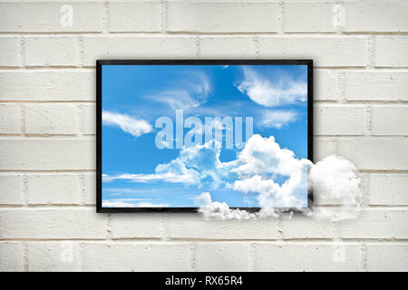 Frame with clouds and blue sky on a white brick wall, thinking outside the box concept Stock Photo