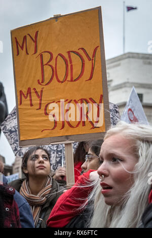 London, UK. 8th March 2019. 3rd International Women's Day Strike. Hundreds of women gather near the Bank of England in central London with placards and wearing symbolic feminist red colours for the annual strike demonstration. The protesters state the strike action is an awareness stand against unfair living and working conditions for migrant women in the many service industries throughout the world including cleaning and childcare which form major labour contributions to prop up the world economy. Credit: Guy Corbishley/Alamy Live News Stock Photo
