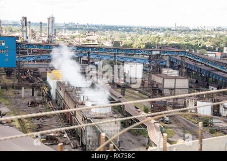 landscape, panorama, view of factory slums with metal hulls and machines for the production of the coking industry, smoking pipes and reconstruction o Stock Photo