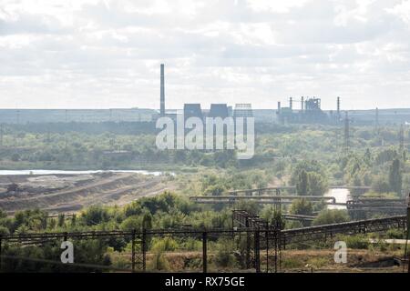 landscape, panorama, view of factory slums with metal hulls and machines for the production of the coking industry, smoking pipes and reconstruction o Stock Photo