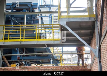 factory workers at Koksokhim, welders are engaged in the construction and installation of metal structures on high ground and in special working condi Stock Photo