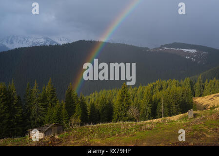Spring landscape with a rainbow in the mountains. Beauty in nature Stock Photo