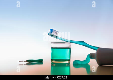 Tools and products for oral hygiene on white table. Horizontal composition. Front view. Stock Photo