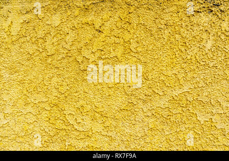 A close-up of a yellow stucco wall. Stock Photo