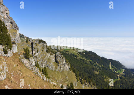 View from Aggenstein mountain (Allgaeu Alps) to the summit station of Breitenbergbahn and a sea of clouds above the alpine upland. Bavaria, Germany Stock Photo