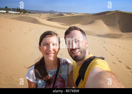 Tourist couple selfie in desert sand dunes of Gran Canaria, Canary Islands, Spain. Stock Photo