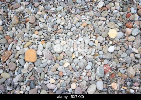 Pebbly beach background from Crete, Greece. Shingle beach. Stock Photo