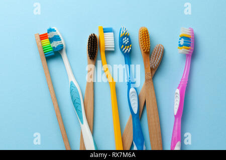 Colored toothbrushes on blue background Stock Photo