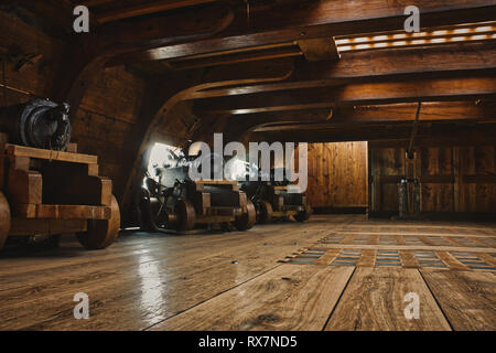 Interior of a gun deck on a historic warship with cannons Stock Photo