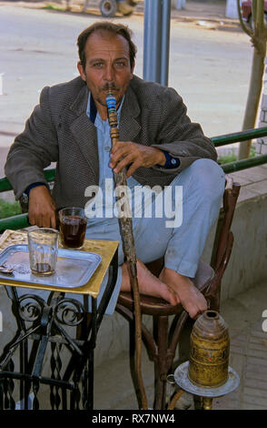 Arab man smoking a traditional Arabian shisha. Saqqara (Egypt). Stock Photo