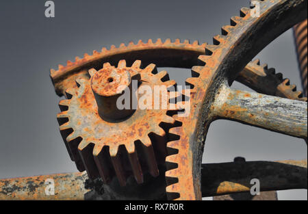 Old rusty metal industrial gears or cogs used in retro machinery Stock Photo