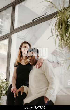Portrait Of Young Couple Posing Against Grey Background High-Res Stock  Photo - Getty Images