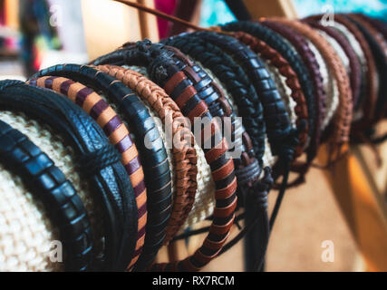 Assorted handmade genuine leather bracelets on display for sale Stock Photo