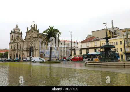 PORTO, PORTUGAL - JUNE 21, 2018: Praça de Gomes Teixeira square with Fonte dos Leões fountain with Carmelitas and Carmo Churches on the background in  Stock Photo