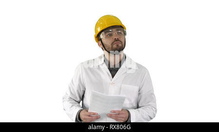 Medium shot. Site engineer cheching papers and something around him on white background. Professional shot in 4K resolution. 004. You can use it e.g.  Stock Photo